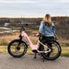 A pink Kingbull electric bike is parked in the trail.