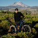 Man cycling the Kingbull rover2.0 e-bike in the grass and smiling.