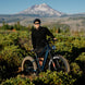 Man cycling the Kingbull rover2.0 e-bike in the grass and smiling.