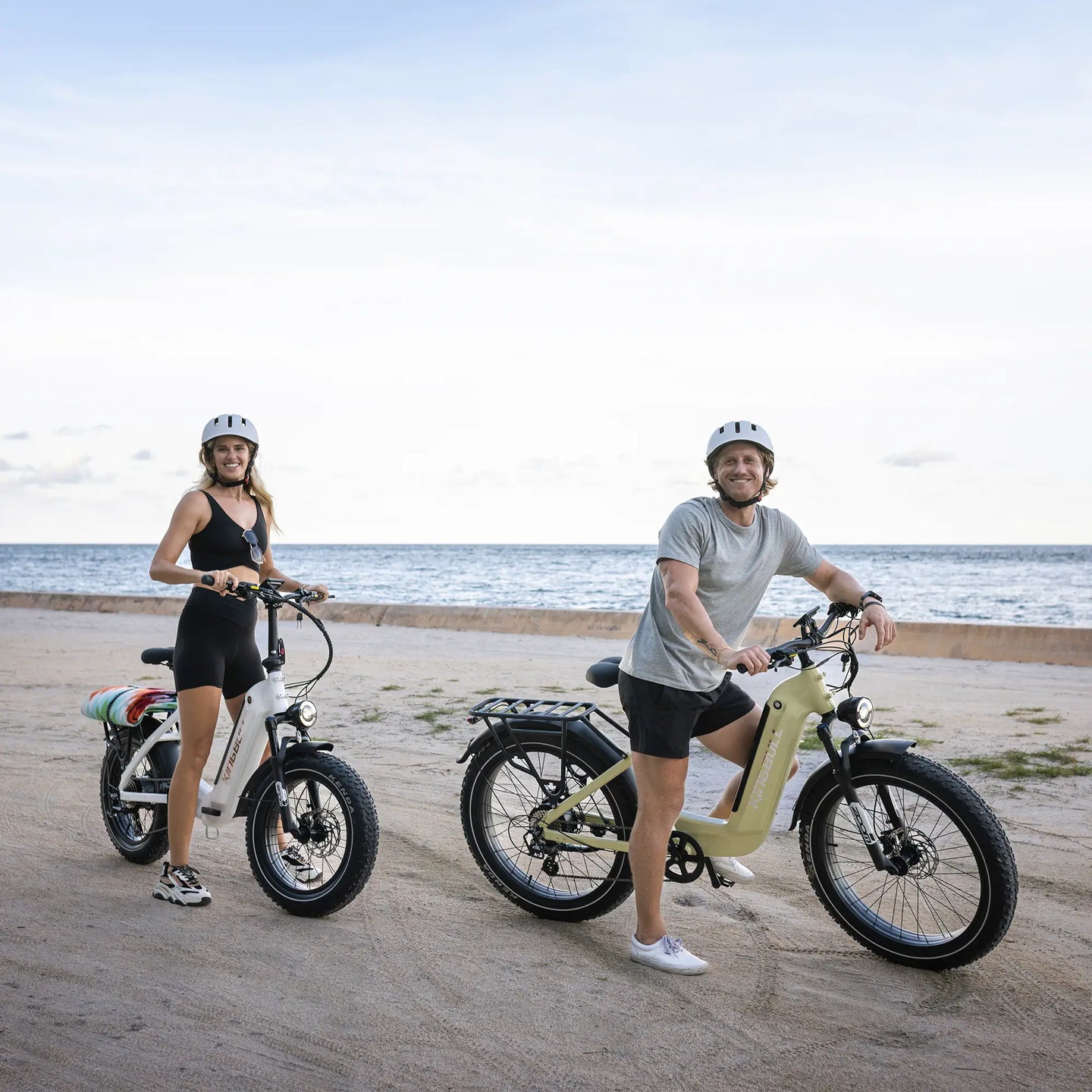 A man and a woman on the beach with their kingbull electric bike