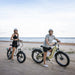 A man and a woman on the beach with their kingbull electric bike