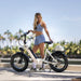A beautiful girl is looking at her new electric bike