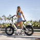 A beautiful girl is looking at her new electric bike