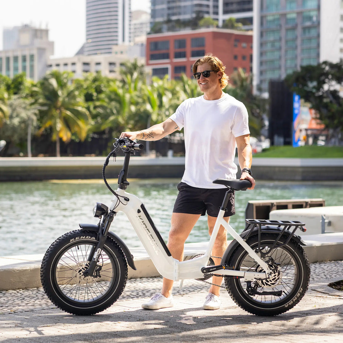 A man with his electric bicycle in a city park