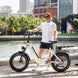 A man with his electric bicycle in a city park